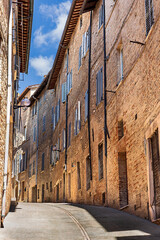 The historic streets of Urbino, a medieval town in Marche, Italy, with charming stone buildings and steep, winding staircases. Urbino, Marche, Italy