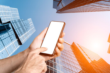Mobile Phone Screen Mockup Held in Hand Against Towering Downtown Skyscrapers