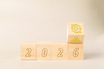Wooden blocks showing the year 2026 with a flipping cube transitioning from gold bars to a Bitcoin icon, representing the future of digital currency, financial evolution, and crypto investment.
