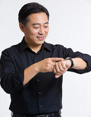 Asian man checking time on his wristwatch isolated on white background.