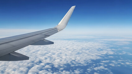 A plane wing flying high above the clouds under blue sky