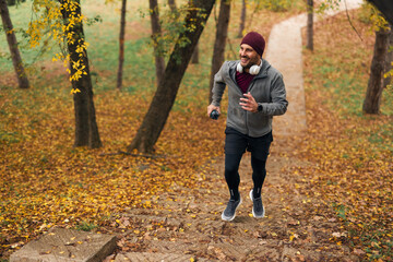 Man running up stairs in autumn park