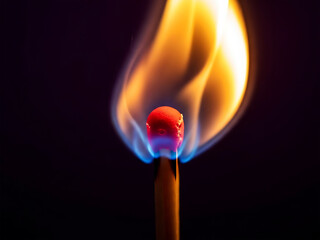 Burning matchstick with flame on dark background