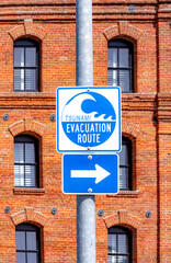 signage tsunami evacuation route with direction arrow