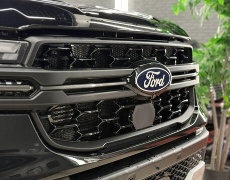 Black Ford Ranger Supercrew 4X4 XLT SUV car logo on radiator grille. USA Ford logo, luxury car dealer and manufacturer, global automobile manufacture. American SUV car. 