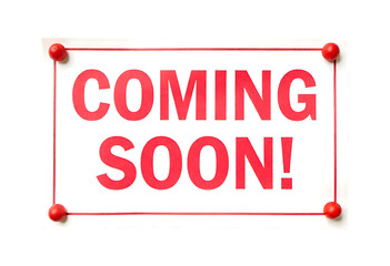 Coming soon sign with red text and push pins