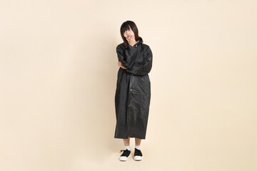 20s Asian woman wearing raincoat