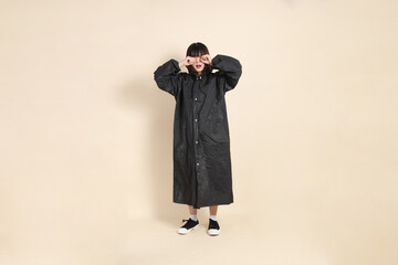 20s Asian woman wearing raincoat