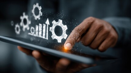 A person interacts with a tablet displaying gear icons and a bar graph