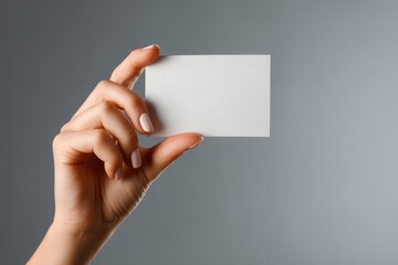 Fototapeta premium Professional studio image of a hand offering a blank card with soft lighting