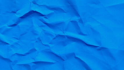 Crumpled blue kraft paper texture background with copy space. Abstract wrinkled blue paper surface...
