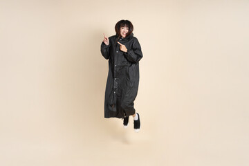 20s Asian woman wearing raincoat