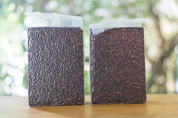 Organic brown rice in vacuum packaging. Riceberry rice is dark purple rice similar to ripe berries, rich in nutrients and has good antioxidant properties.