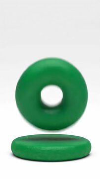 Creating a green ball with clay on a plain background in a small workspace setting