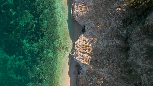 Top Down Drone Flight Along Spiaggia di Sansone Beach &ndash; Turquoise Water and Rocky Coastline, Elba Island Italy
