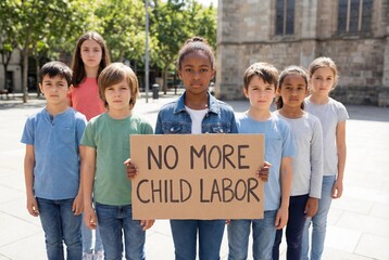 Diverse group of children advocating against child labor holding a protest sign outdoors