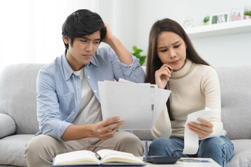 Fototapeta premium Family financial concept, Stressed wife and husband have a problem to pay loan can not pay credit card debt.