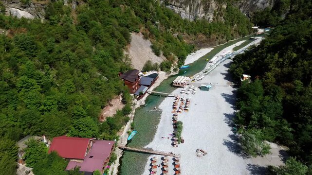 Drone shot of crystal clear blue water flowing through the Shala River valley, Albania