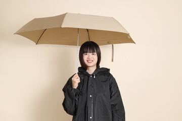 20s Asian woman wearing raincoat