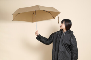 20s Asian woman wearing raincoat