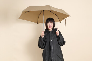 20s Asian woman wearing raincoat