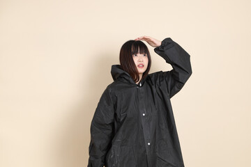 20s Asian woman wearing raincoat