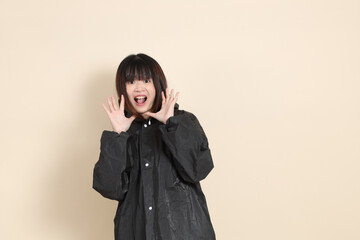 20s Asian woman wearing raincoat