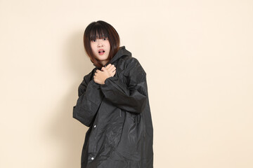 20s Asian woman wearing raincoat