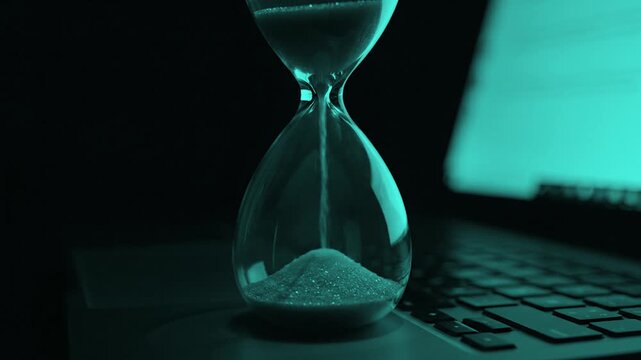 Digital Deadline Hourglass on Laptop Keyboard, work deadline concept