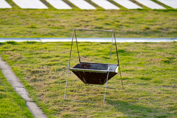 Naklejka premium Grill stand on green lawn, ready for use