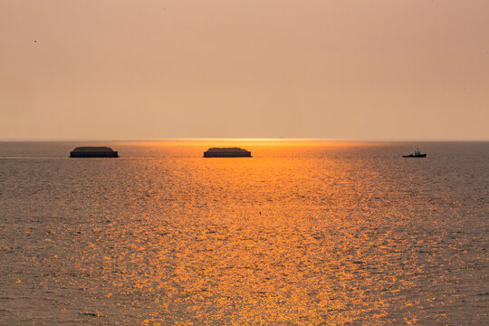 Tugboat hauling two sand barges, Strait of Juan de Fuca.