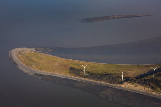 Wind turbines on Fire Island near Anchorage, an aerial view of the island, and three turbines.