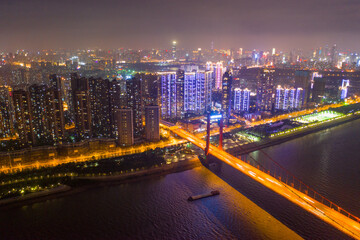 Fototapeta premium Aerial Night City Scene with Sparkling Rivers and Illuminated Bridge