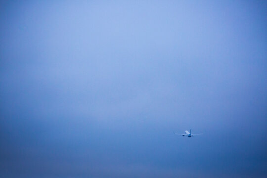 An aircraft taking off in a clear blue sky.
