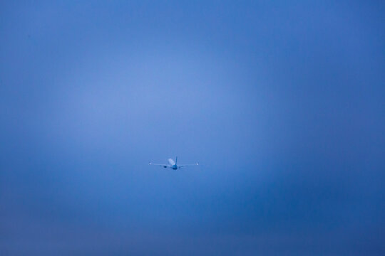 An aircraft taking off in a clear blue sky.