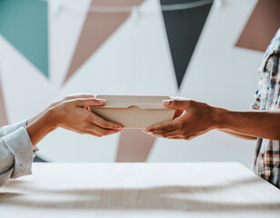 Hands Exchanging Brown Food Box Delivery
