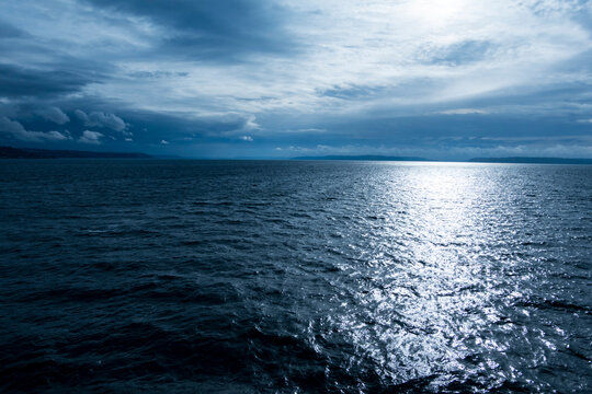 Rough water on Puget Sound, clouds in the sky.