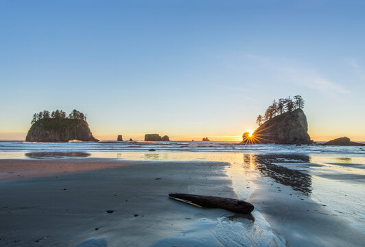 Second Beach at low tide, seastacks offshore silhouetted at sunset.