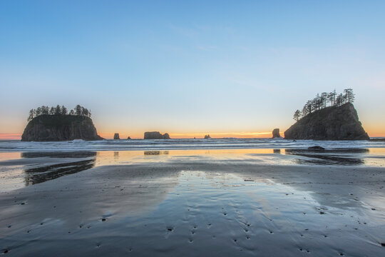 Second Beach at low tide, seastacks offshore silhouetted at sunset.
