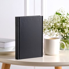 A stylish white vase filled with vibrant, colorful flowers sits atop a stack of neatly arranged books, creating a charming and inviting display.