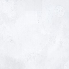 A textured white wall adorned with various colorful paint stains, showcasing splashes of blue, red, and yellow, creating an artistic, vibrant backdrop.