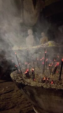 Sri Lankan Buddhist temple night view Buddha statues burning incense sticks full moon poya day atmosphere.