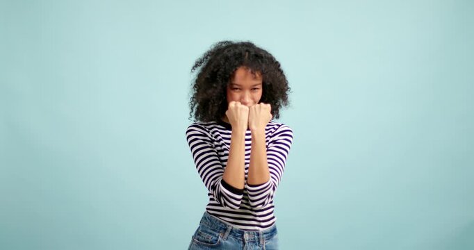 Happy african american woman celebrating success and dancing