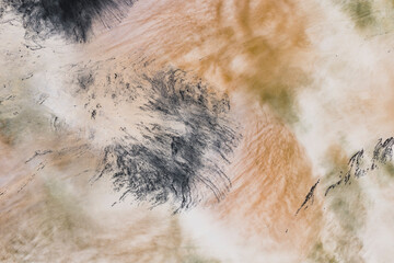 Long exposure of moving water, churning and flowing, surface highlights, impressionistic blurred effect. 