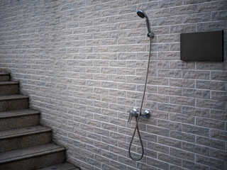 Shower and Staircase Adjacent to Brick Wall