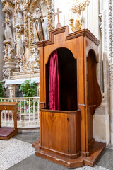 Ancient wooden confessional in a Church a in Lecce