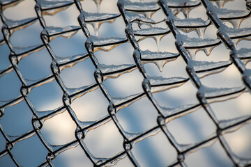 Frosted metal fence with ice and snow, weather, winter time, pattern, background