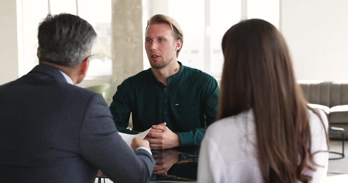 Smiling young adult male job applicant shaking hands with interviewer HR manager after successful interview in company office. Hiring process, human resources, employment and new career opportunities