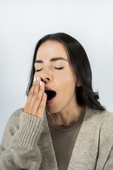 Young mexican woman yawning covering mouth feeling sleepy