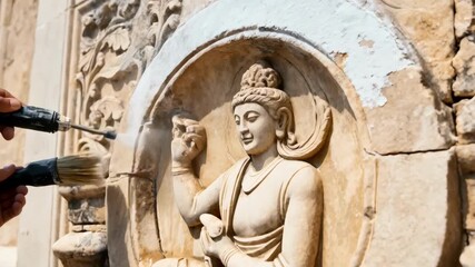 Restoration team uses gentle techniques to clean weathered stone surfaces preserving the delicate features of a culturally significant historic edifice.